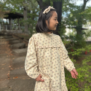 mutta.の女の子向けの秋冬ワンピース。愛らしい小花柄をちりばめた上品なベージュカラーワンピース
