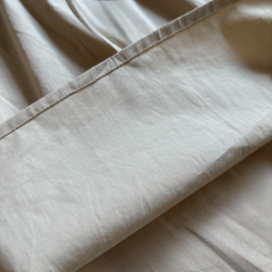 ベージュのクラシカルワンピースを着る女の子。胸元に小花柄とレースが施され、秋冬のお出かけや家族写真にぴったりの子供服